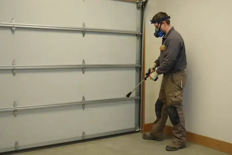 Rodent Prevention Services in Corvallis: pest management professional is installing a brush seal along the bottom edge of a